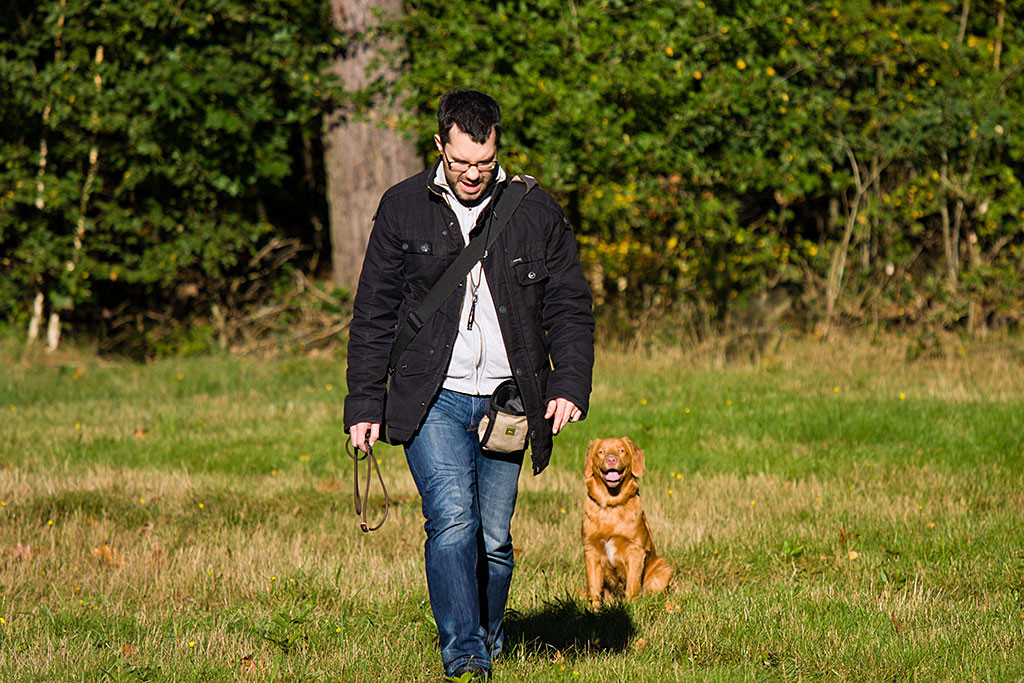 Edison sitzt auf der Wiese während sich Stephan von ihm entfernt