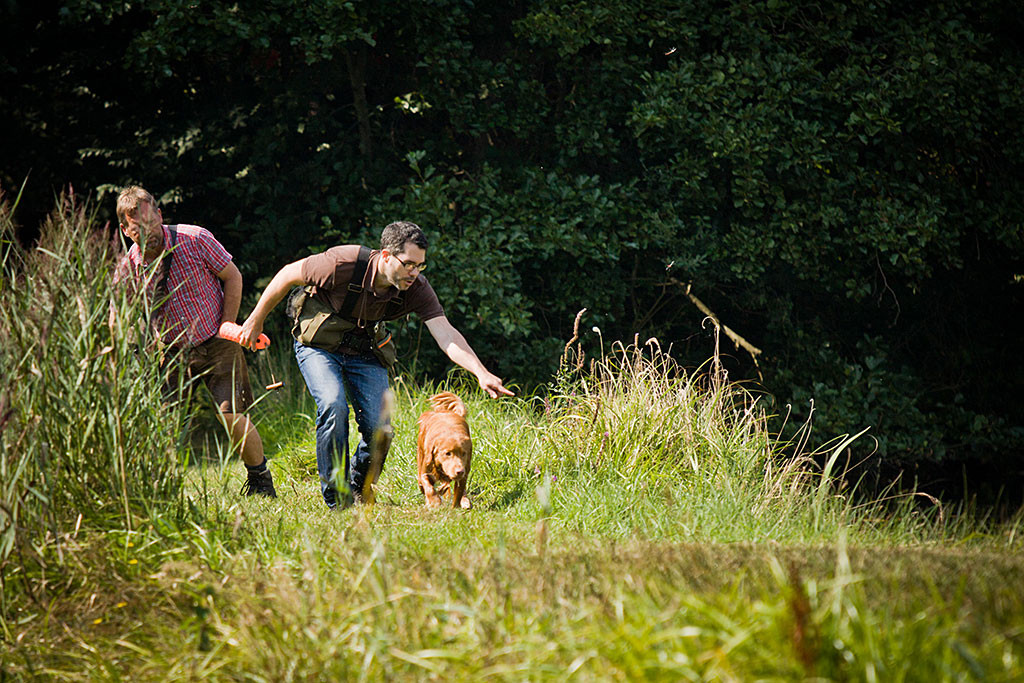 Edison sucht Dummies in Ufernähe, Stephan zeigt ihm wo, im Hintergrund steht Carsten und beobachtet genau