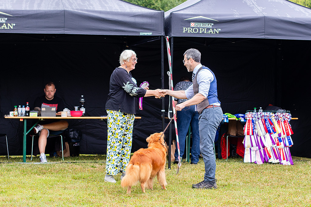 Edison steht zwischen Stephan und der Richterin, die Stephan zum Sieg der Veteranenklasse gratuliert